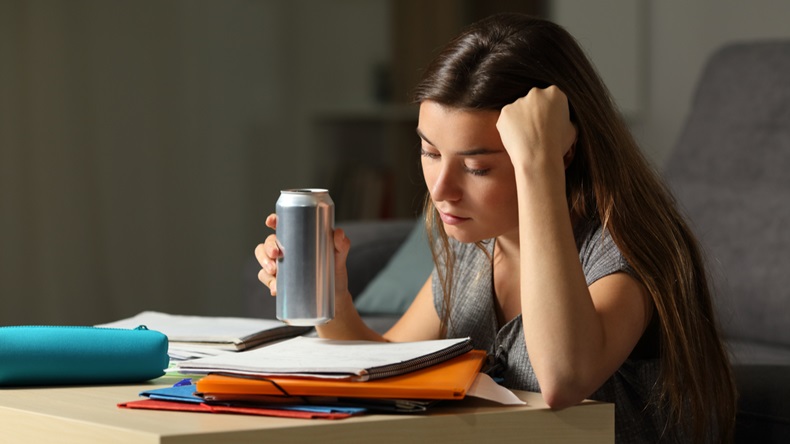 student studying with canned drink