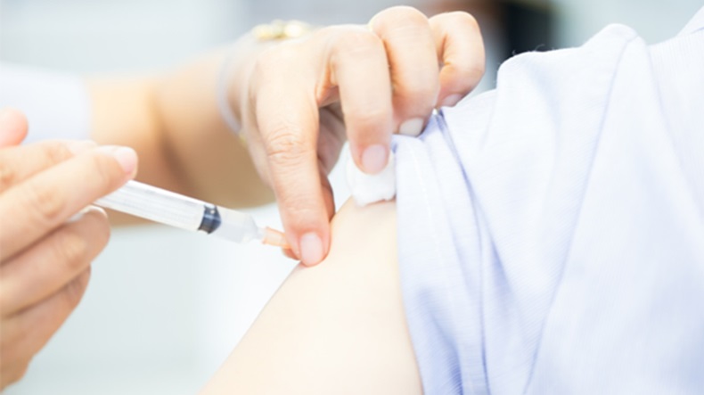 Pharmacist giving flu vaccine 