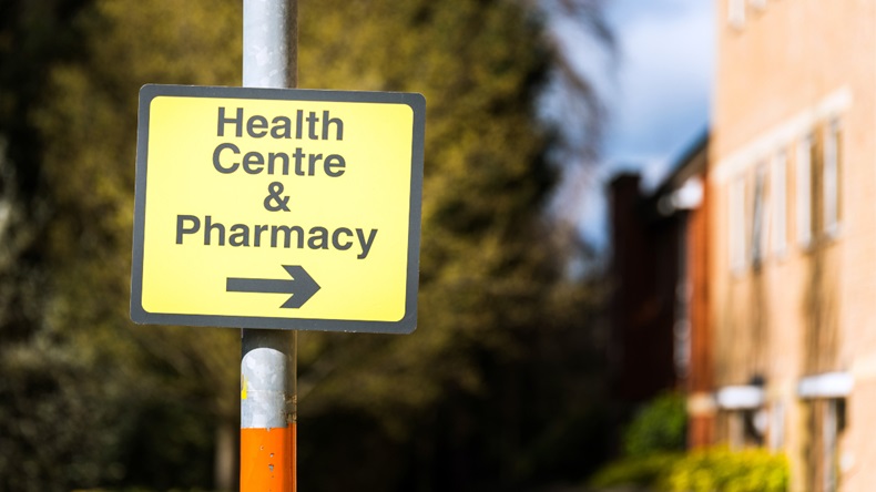 Sign pointing the way to a health centre and pharmacy