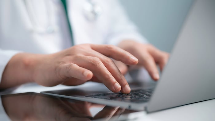 Doctor typing on computer