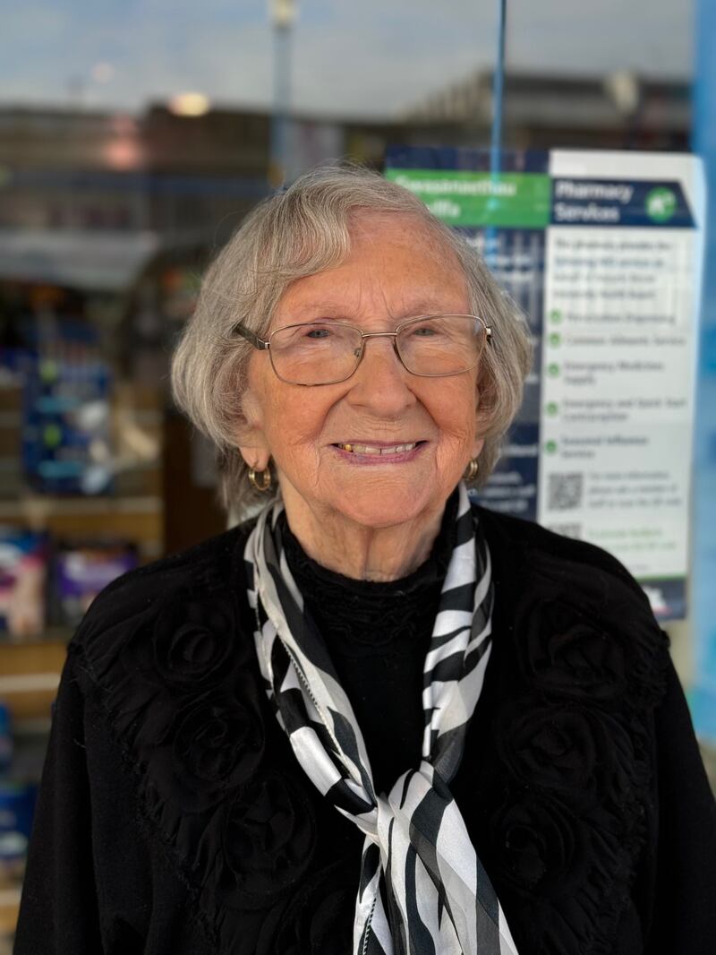 A woman with grey hair smiling at the camera