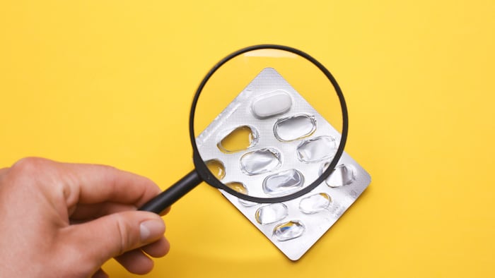 Magnifying glass blister packet of pills