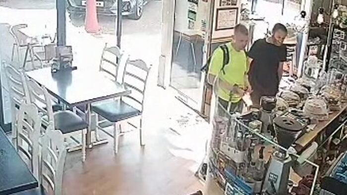 CCTV footage of two men at the till in a cafe