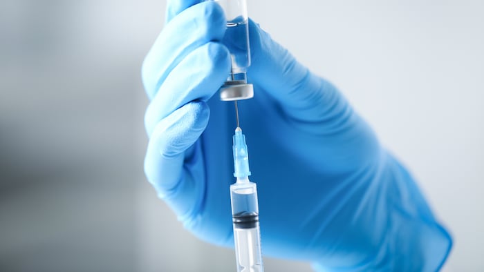 Vaccine in gloved hand