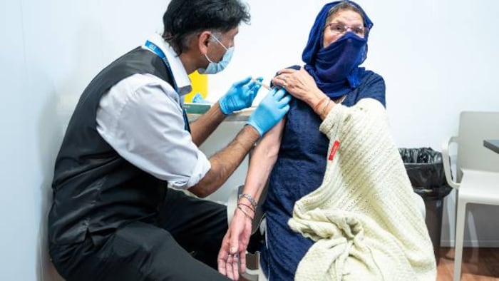 Asda pharmacist administering COVID jab