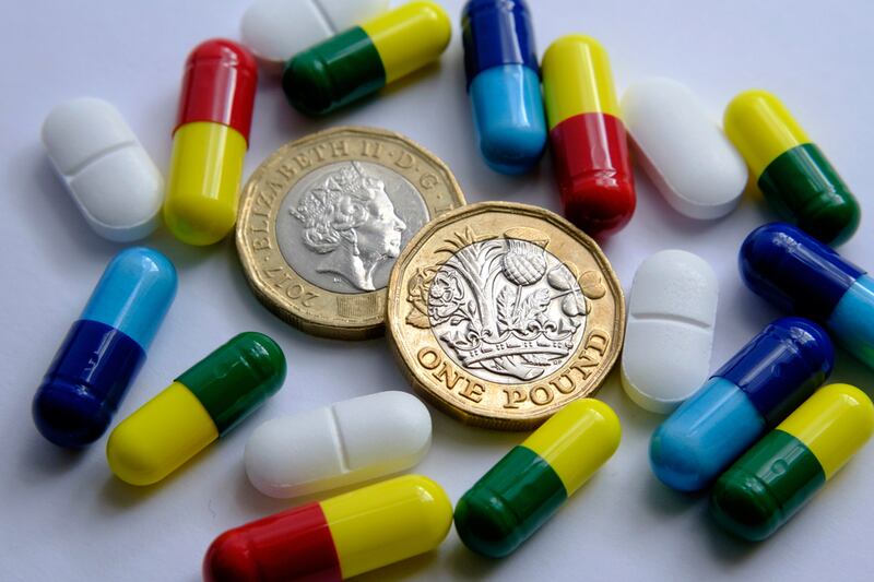 Pile Of Different Pills Placed Around Two British Pound