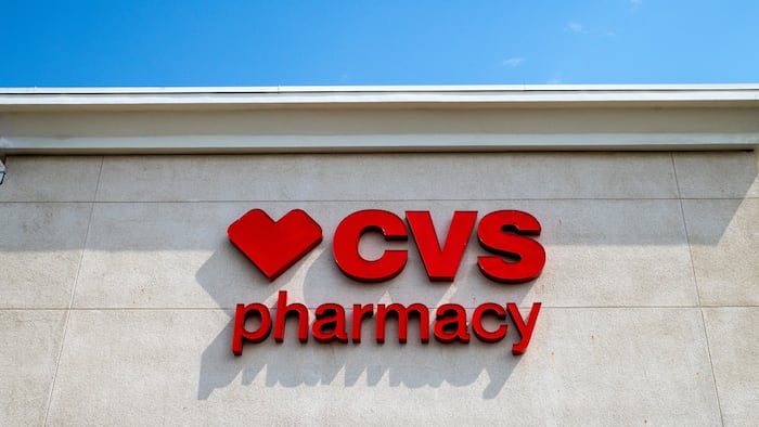 A CVS Pharmacy sign on a building, below a blue sky