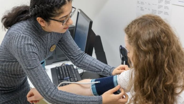 Pharmacist taking patient's blood pressure