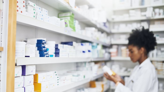 Pharmacist checking stock