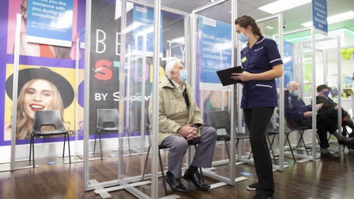 Patient waiting to go inside a Superdrug pharmacy