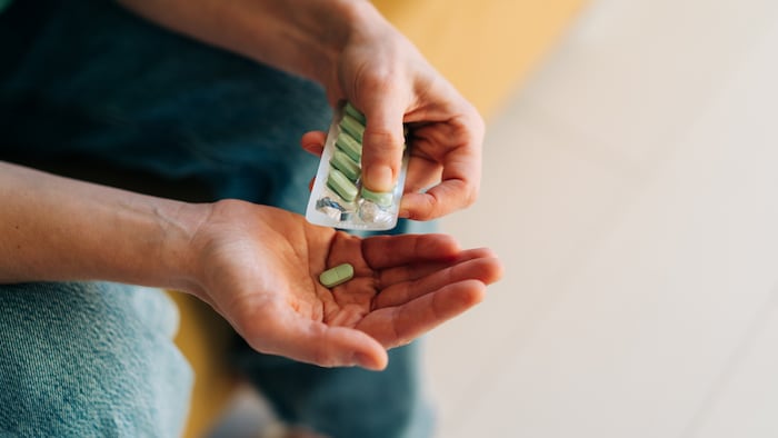 Person taking tablets out of a blister pack