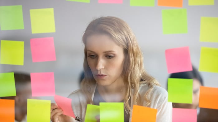 Woman looks at sticky notes