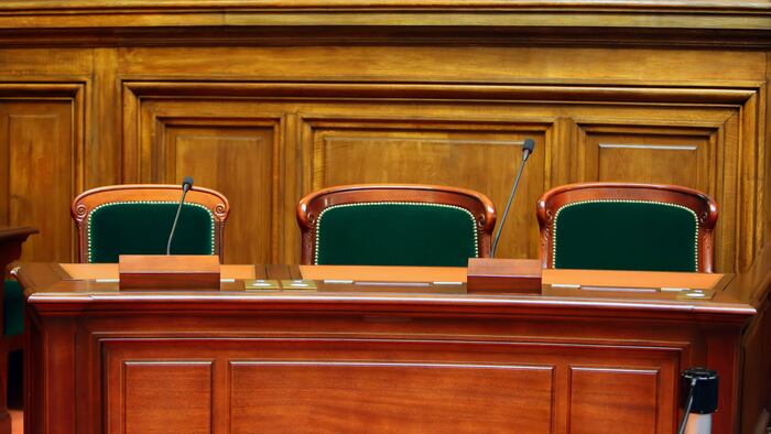 Empty vintage court's room with table,chairs and microphones.