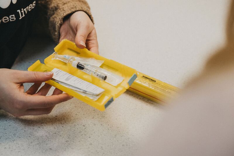 an open packet showing a naloxone syringe