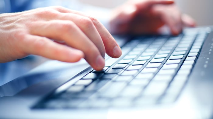 Hands typing on keyboard