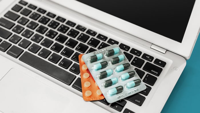 Blister packs of pills on computer/laptop keyboard