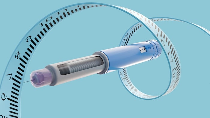 GLP-1 pen with a measuring tape wrapped around it