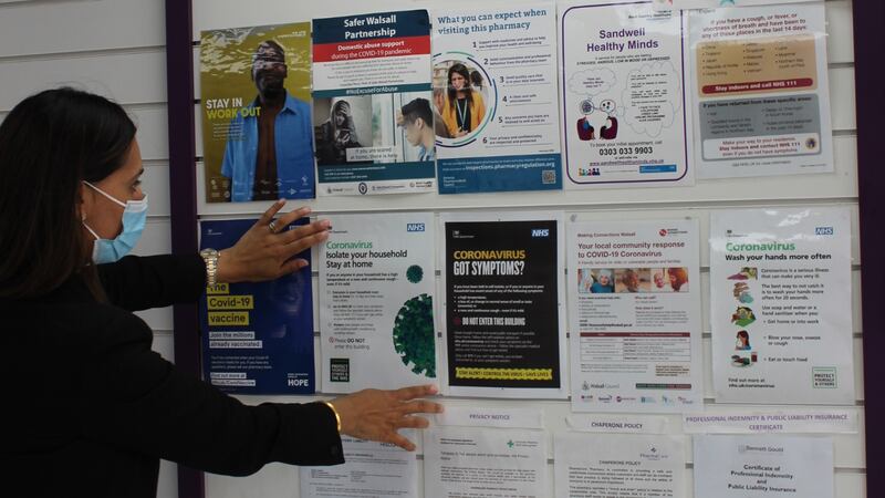 Sukhy Somal displays COVID-19 notice at her pharmacy