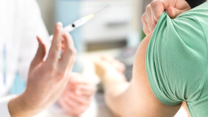 Pharmacist giving COVID booster vaccine
