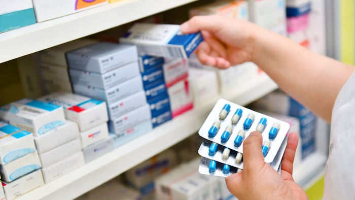 Pharmacy hands pill