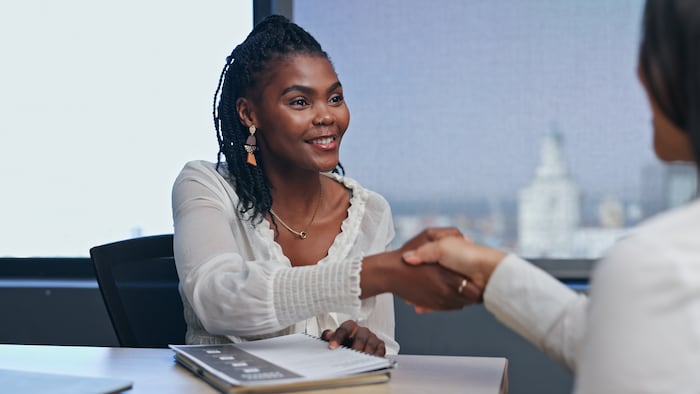 Two businesswoman shaking hands in a job interview