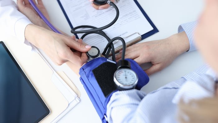 doctor-cardiologist-measuring-blood-pressure-patient-1909024012