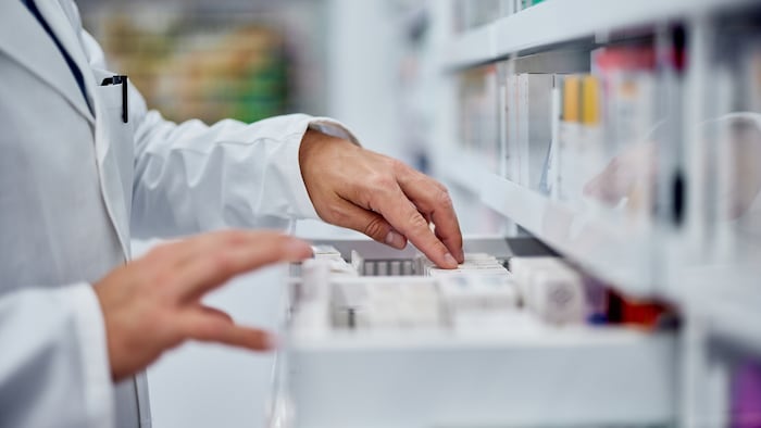 Pharmacist looking at medicine stock