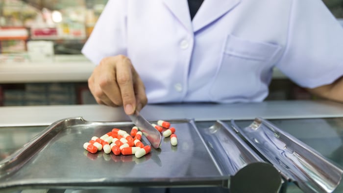 Pharmacy technician counting pills