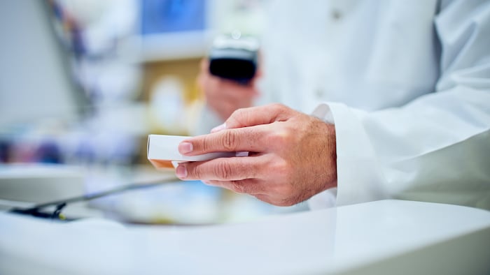 Pharmacist scanning medicine