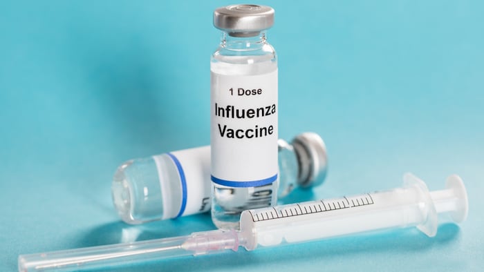 Influenza Flu Vaccine Vials With Syringe Over Turquoise Background - Image